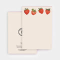 A stationery notepad set by Salted Caramel Company, featuring a cream-colored cover decorated with four watercolor red strawberries, and a matching cream back cover with black printed text and a circular stamp design.