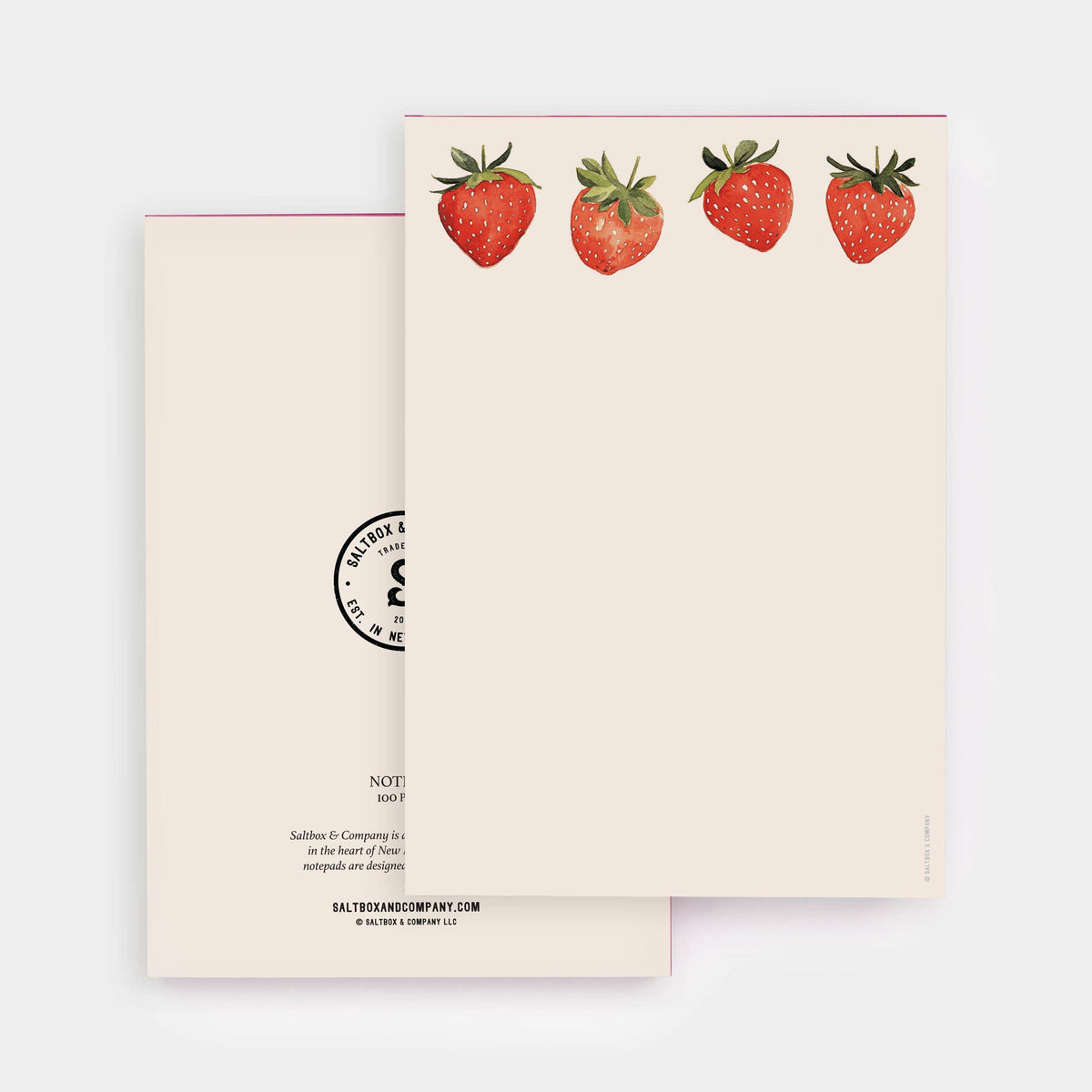 A stationery notepad set by Salted Caramel Company, featuring a cream-colored cover decorated with four watercolor red strawberries, and a matching cream back cover with black printed text and a circular stamp design.