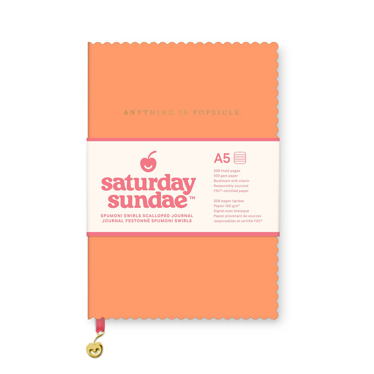 A Saturday Sundae A5 journal with a bright orange cover and a white paper band around the middle, shown on a plain white background.