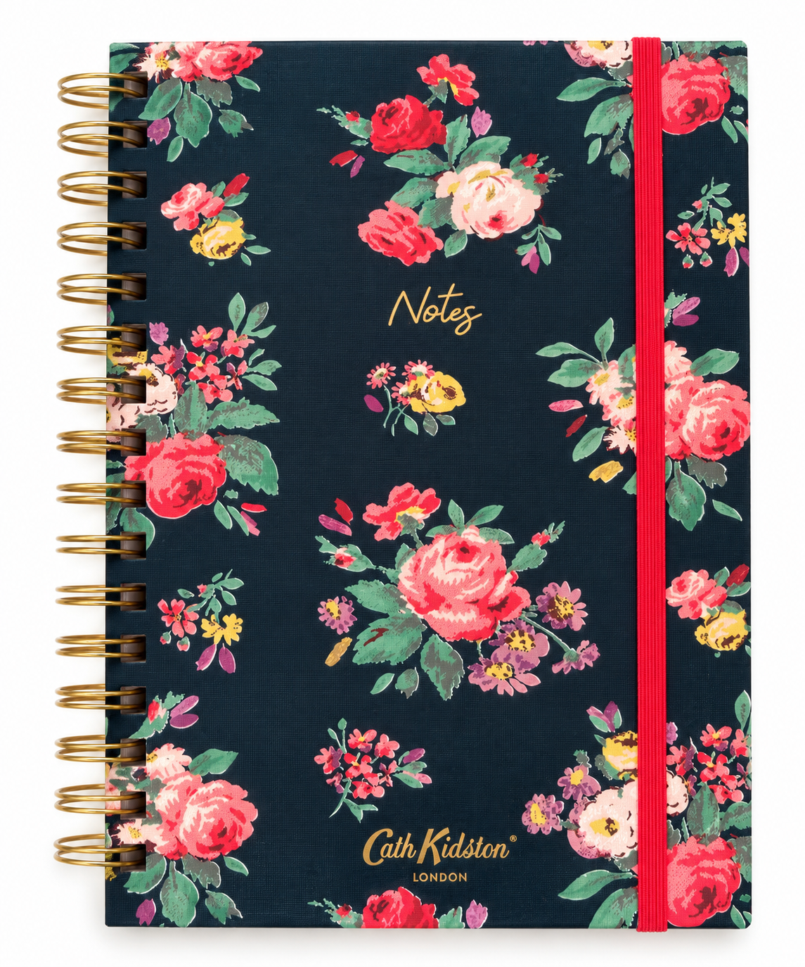 A spiral-bound notebook by Cath Kidston London with a navy blue cover decorated with a vibrant floral pattern of pink, red, and yellow roses with green leaves. It features a red elastic closure band and gold wire binding.